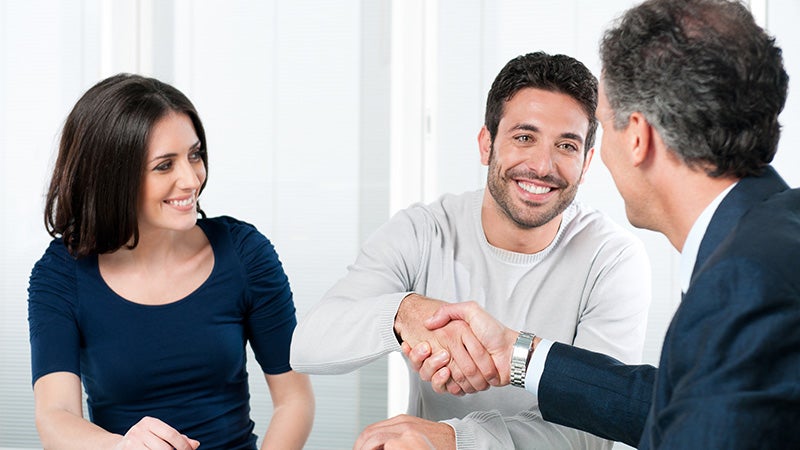 couple shaking hands with salesman Grand Island Cadillac in GRAND ISLAND NE